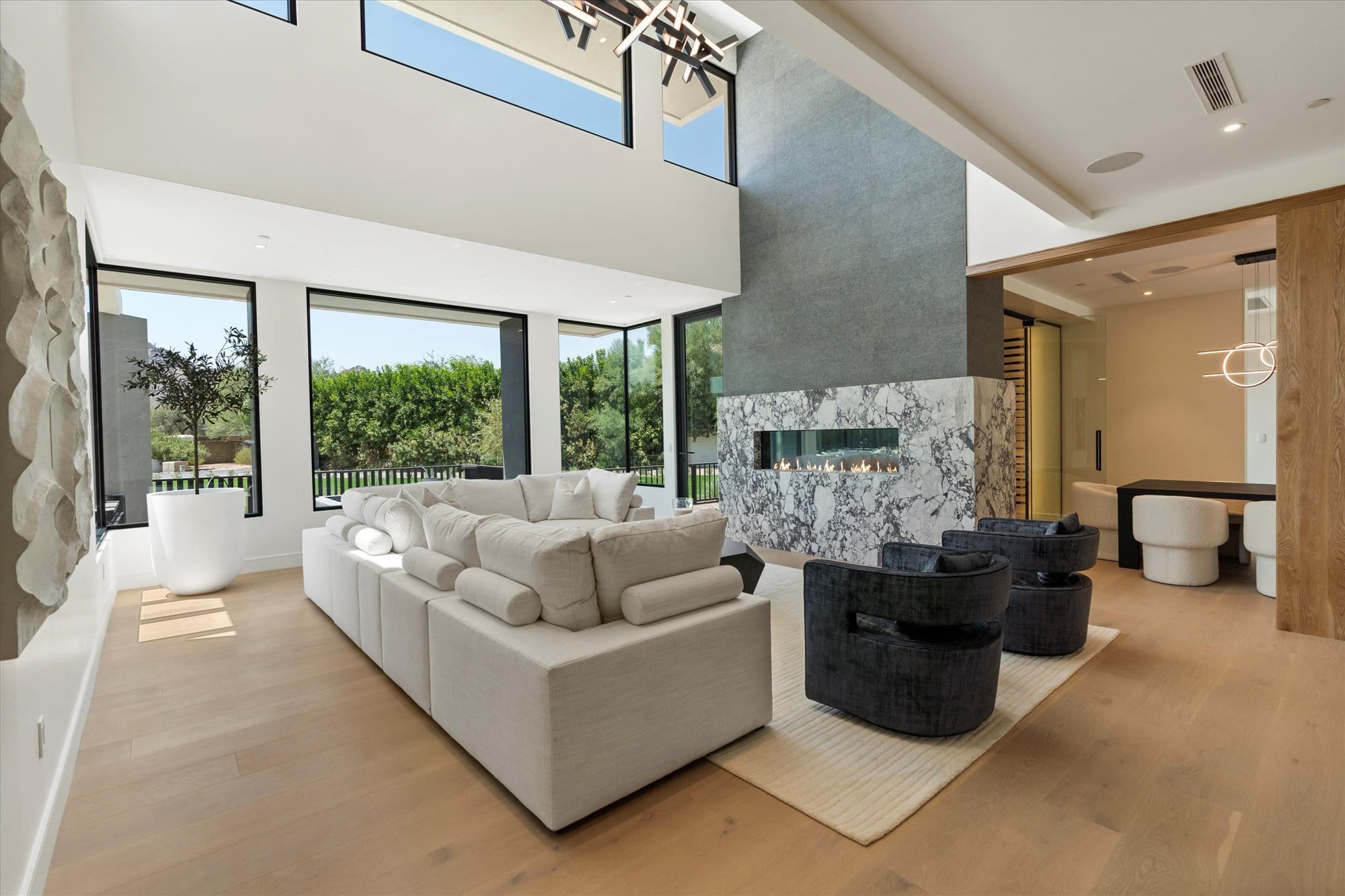Great room with stone fireplace and mountain views
